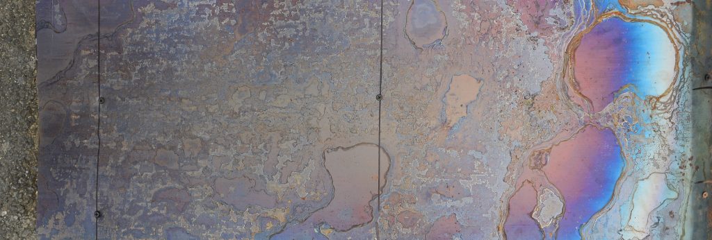 Abstract corrosion texture on the copper plated steel sheet. Random pattern in orange and blue colors